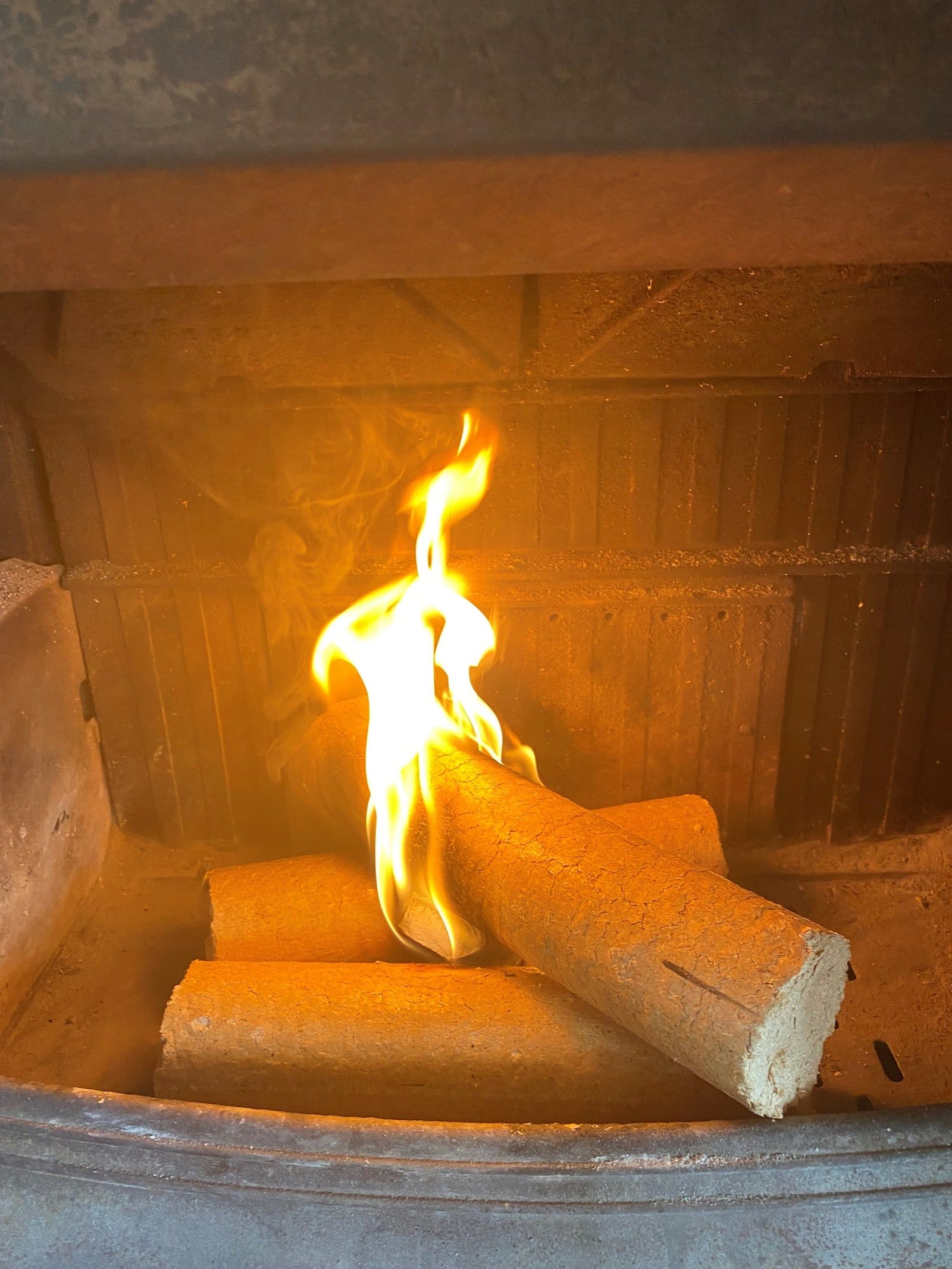An eco log catching fire in a fireplace